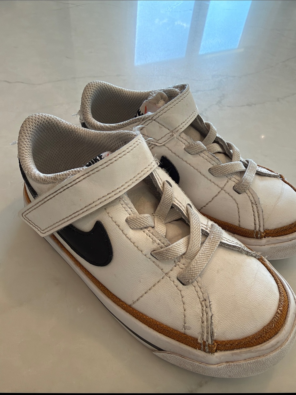 Nike Kids White Sneakers with Black Swoosh and Brown Trim